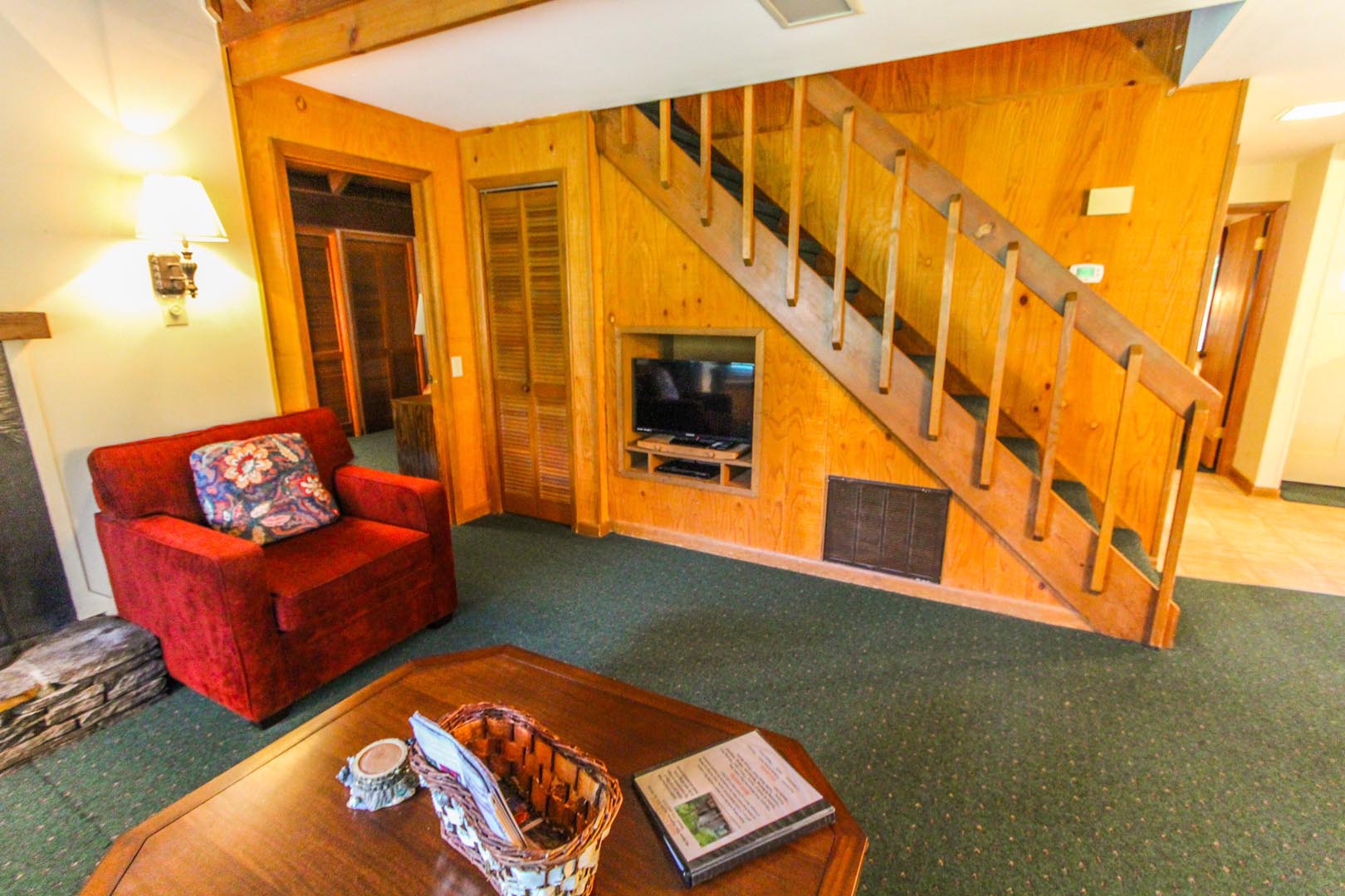 The living room and stairs to the bedrooms at VRI's Golf Club Villas in Marble Hill, Georgia.